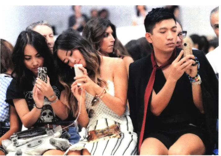 Figure 4.  Fashion bloggers  holding smartphones at a New  York fashion week  show