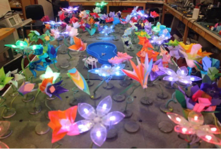 Fig. 1. The Robot Garden is a heterogeneous collection of distributed robots, including 100 actuated origami flowers and mobile foldable insects.