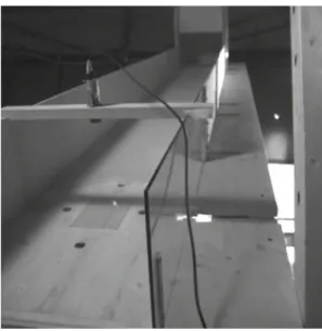 Fig. 1 Front view of the granular chute: force plate in the centre, ultra- ultra-sonic flow height sensor above it and optical velocity sensors on the ground are visible