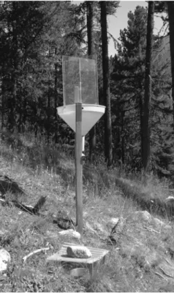 Fig. 1 Trap station at Celerina, Grisons (1,730 m a.s.l.), consisting of a flight trap (combination of plexiglass interception trap and a yellow water pan) and a covered pitfall trap in the ground