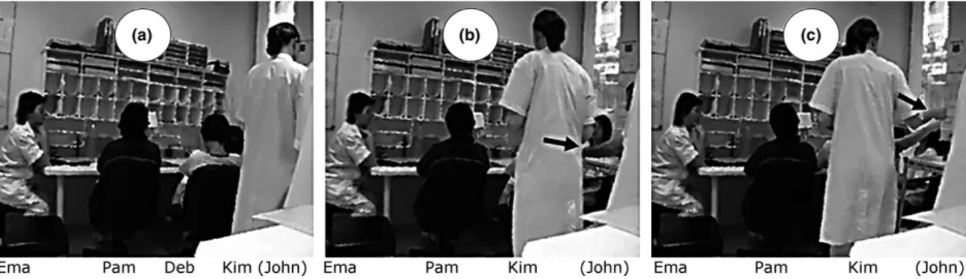 Figure 2. Bodily request of a document. (a) Initial position of participants. (b) John touches Deb’s shoulder (see arrow) and Kim moves to the table