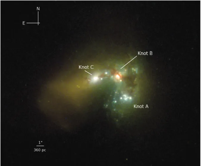 Figure 1. The starburst regions in Haro 11. The image is the result of the combination of the WFPC2 F814W filter in red, and the two ACS filters: F435W in green and F220W in blue