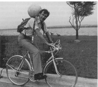 Fig. 1. By-passing officialdom: Dr John R. Vallentyne riding a bicycle in Burlington, Ontario, with 'The Biosphere'on his back.