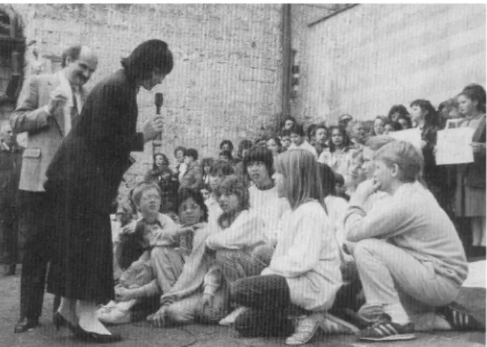 FIG. 1. The Author (holding microphone) and RAI (Italian Televi- Televi-sion) interviewing some of the children in the grounds of the Basilica