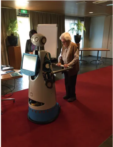 Figure 1. Older individual uses ASTRO robot as a mobility support.