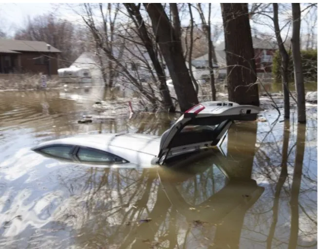 Figure  (0.2):  “A  submerged  car  is  seen  in  Sainte-Marthe-sur-le-Lac.  Quebec  April  30, 