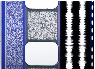 Figure 3.6: A photo of a 35 mm film print featuring four au- au-dio formats – from left to right: SDDS (the area to the left of the sprocket holes), Dolby Digital (the area between the sprocket holes labeled with the Dolby Double-D logo in the middle), ana