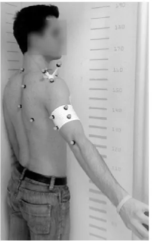 Figure 1 — A subject equipped with markers and the acromion marker  cluster, posing in the cabin dedicated to low-dose biplanar radiograph  measurements.