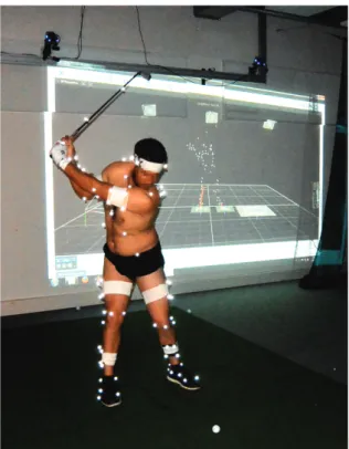 Fig. 1. Photograph of the experimental set up with a golfer equipped with reflective markers (here with an iron-6)