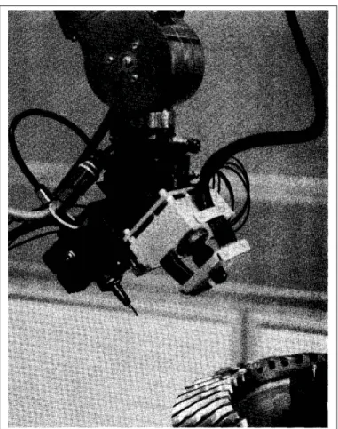 Figure 1.7 Robotic deburring system equipped with a camera Horaud et al. (1992)