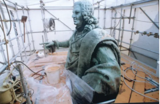 Figure 4. Cleaning of a bronze statue by  walnuts shells with an air abrasive  technique