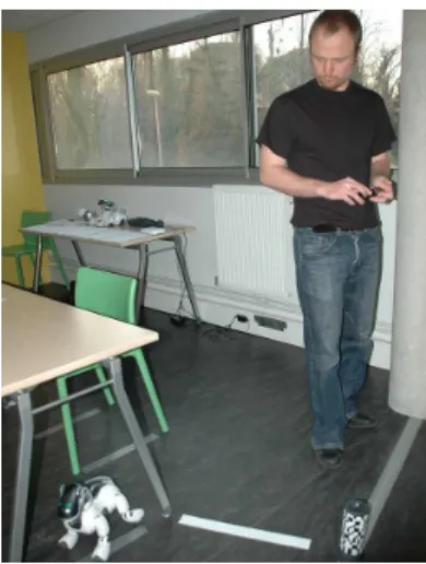 Fig. 1. Using a handheld device as a mediator to control the movements of a social robot.