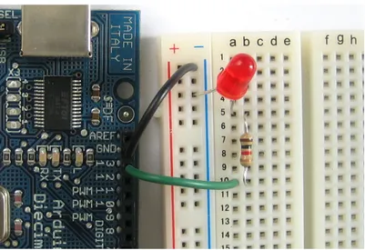 Figure sette.3 An Arduino board with a red LED connected to pin 13 through a 100 Ω resistor.