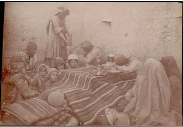 Figure 1. Antoin Sevruguin (attributed), Group with Blankets, Children Sleeping Under Them; Man and Woman with Hookah (Pipe); All in Costume in Stone Courtyard Of Livery; Candleholder and Bowl Nearby 1896