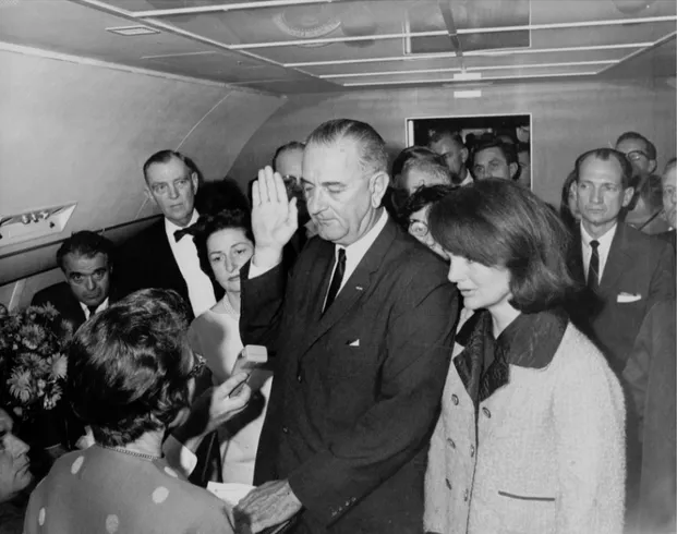 Figure 1. Jack Valenti (far left) as the oath of office is administered to Lyndon Johnson on Air Force One
