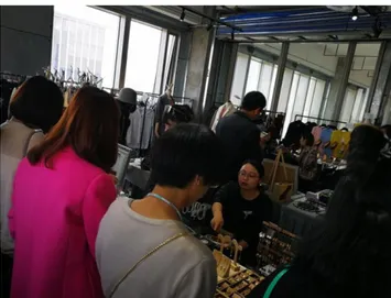 Figure 9: Three members of the public as customers bargaining with a seller in the MODEShanghai trade show while viewing the retail products in front of them ©Wang, 2017
