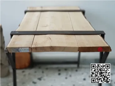 Figure 8. Table made with marked chestnut boards. It is possible to observe the RFID devices (red on  the right), QR code (on the left of the word CREA and on the right of the image) and NFC (on the left  of the QR code)