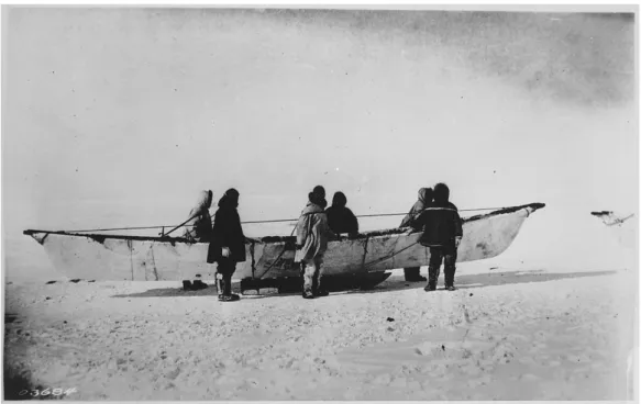 Figure 5. Six Eskimos standing beside native skinboat (umiak) on sled, Point Borrow, Alaska, 1935