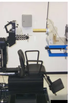 Figure 1.5: Picture of the positioning chair and the last collimator from which the proton beam exits, inside the treatment room at CATANA facility.