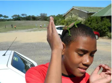 Figure 5: A young man engages with a Cape Dwarf Chameleon at ESNR 