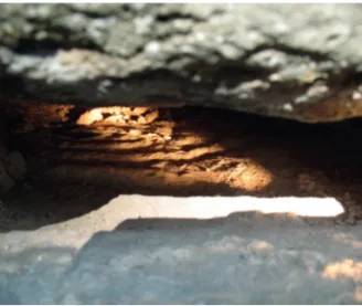 Foto förf. —Palmetto leaf visible on the upper corner of a lily slab in the tower wall of Lindärva church.