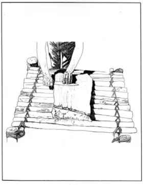 Figure 5. Author grin- grin-GLQJDÁLQWGDJJHURQ sandstone slab and  Douglas Fir pole table.