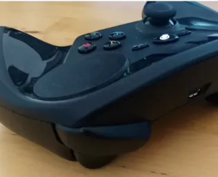 Figure 8. A Steam controller. The two black circles are its  touchpads. 