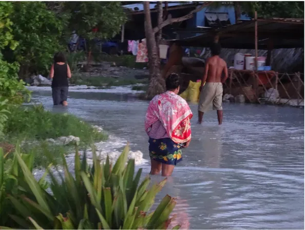 Figure 2: Locals walk through flood waters in Tarawa, Kiribati after a king tide. Credit: Rick Haughton/2015 