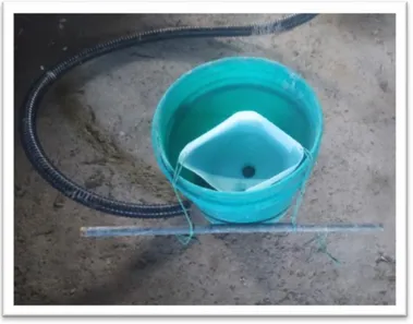 Figure 6. A simple urine separator created by a plastic gallon bottle, a PVC  tube,  rope  and  a  metal  weight