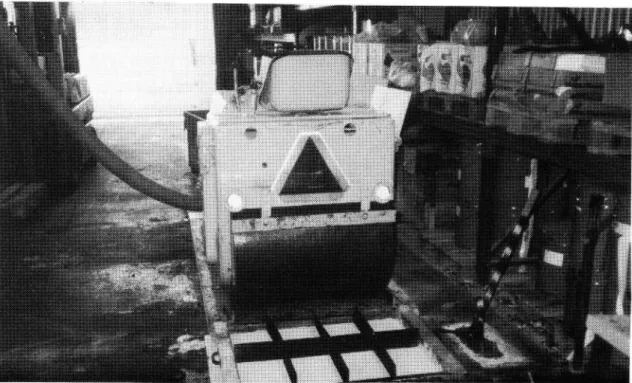 Figure l. Mould and roller for compaction of test slabs. The di vision of the mould into small sections avoids segre gation of the mix and makes for even thickness of the test slab.