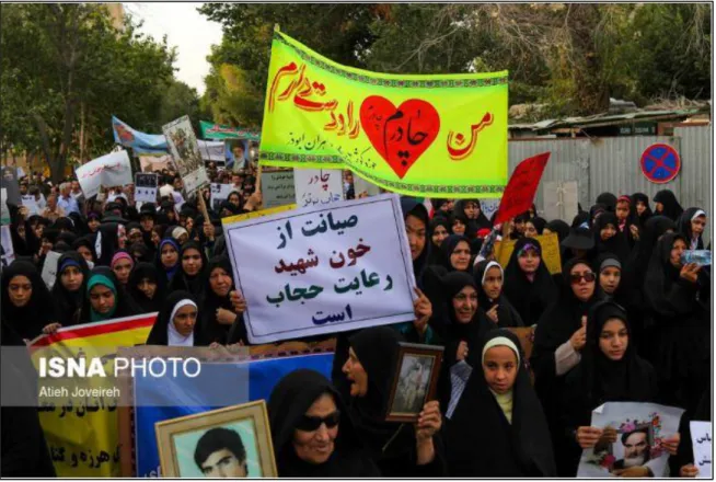 Figure 12. Women holding up banners in hijab march. From ISNA. Retrieved from http://tnews.ir/