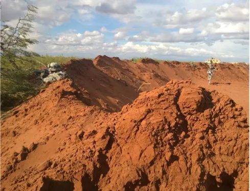 Figure 1-2: Use of temporary berms with soldier securing the perimeter (Crofoot 2015) 