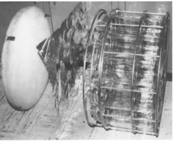 FIGURE 2 Partially exploded view of cylindrical rack for  holding 19 Baxter bottles showing metal lid with polyurethane  foam bonded to underside f  aluminum foil, and twopiece wire rack  -upper section is joined to lower section by three wing nuts