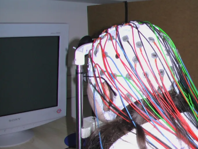Fig. 6. A. Subject of psychophysiological experiment in front of the monitor, wearing   electrode cap with color coded scalp electrodes