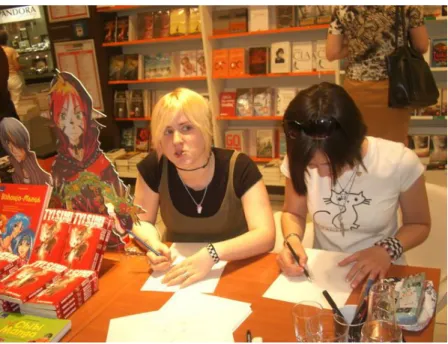Figure 13 Reyhan Yıldırım (on the right) while drawing a Manga  character during her book signing day for the Tylsım series