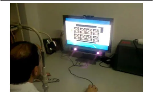 Figure 2 Surgeon using the early version of the SI. The SMI eye-tracker is visible below the monitor.