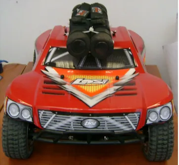 Figure 1. LOSI electric RC car with additional weight on top.