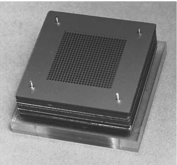 Fig. 5. Photograph of the millimeter-wave PBG crystal built by stacking 16 micromachined silicon wafers.