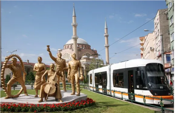 Figure 2. A famous angle of contemporary Eskişehir urban center with statues, tramline and Reşadiye  Mosque, photo by Kaplan, 2007