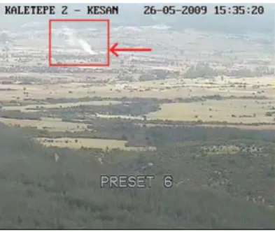 Fig. 3 Snapshot of a typical wildfire smoke captured by a forest watch tower which is 5 km away from the fire (rising smoke is marked with an arrow).