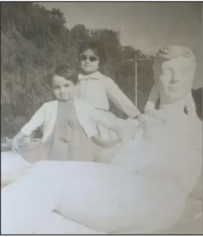 Figure 20. Photograph serving as a material trace of memory that shows two children playing  with the sculpture of a naked woman  