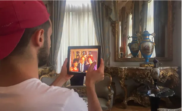 Figure 7. Sabancı and his family in front of a Serves vase on tablet computer 
